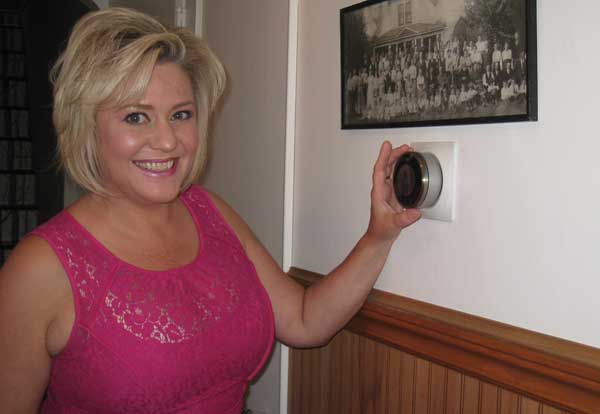 Kari Sorensen with Nest thermostat Photo of Kari Sorensen with Nest thermostat