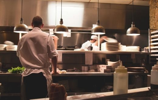 Stainless steel kitchen of a restaurant busy with activity