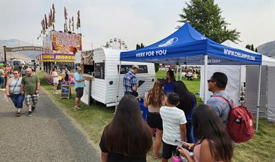 2075 Outreach_ Chelan County Fair sm Photo of customers visiting outreach tent at Chelan County Fair