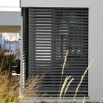 External louvered shade on a house window