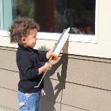Child holding caulking gun