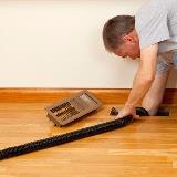 Person vacuuming out air ducts
