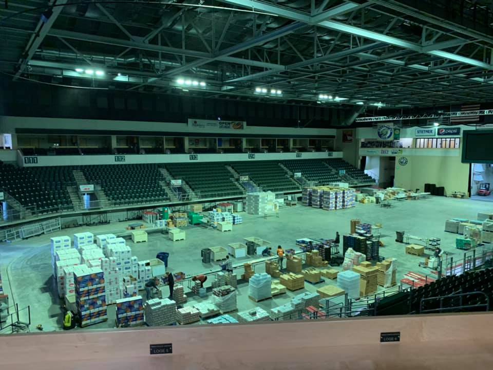 Food distribution at Town Toyota Center arena filled with food boxes