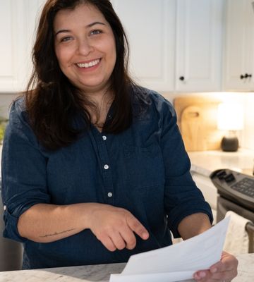 Chelan PUD customer reading electric bill with smile