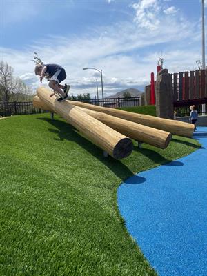 Riverfront playground Evan Boy jumps over logs at the new apple-themed playground at Riverfront Park