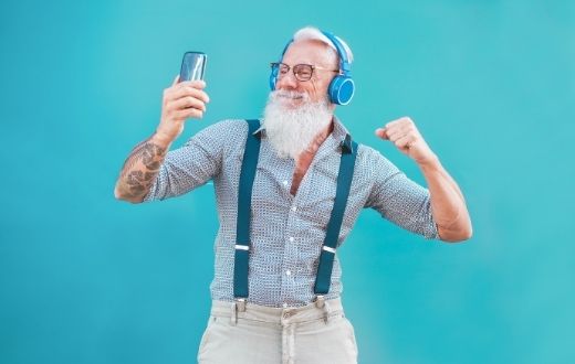 Senior discount - senior man with white hair and beard dancing