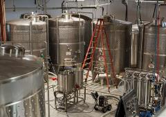 industrial cider tanks in a warehouse