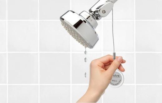 smart start thermostatic showerhead in tiled bathroom