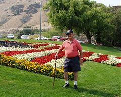 Tony DeRooy bench dedication 004 copy Photo of Tony DeRooy in front of American flag garden bed at Rocky Reach