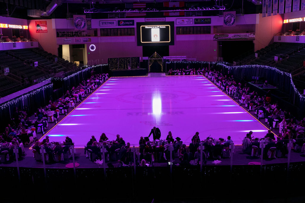 Town Toyota Center Winter Gala with purple rink lighting and spotlights 