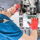 HVAC maintenance person inspecting air handling unit