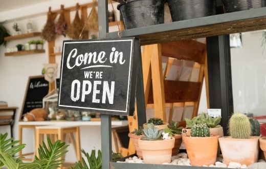 Retail shop with "come in, we're open" sign