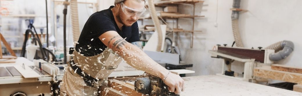 Small business - person wood working in shop with power tools